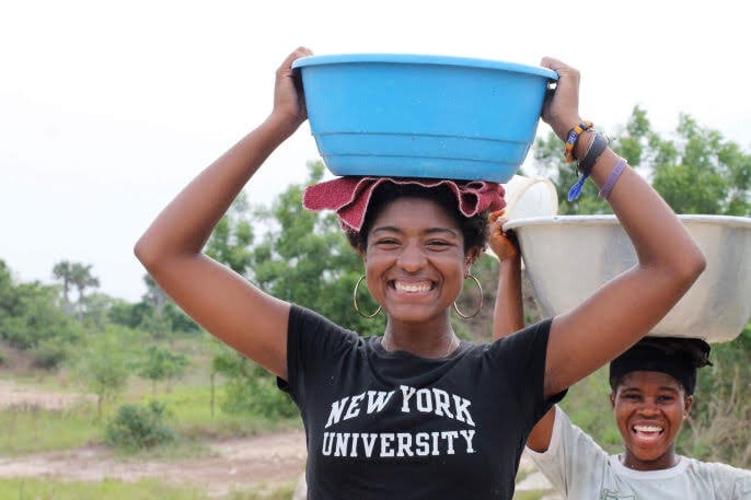 Alexis M., NYU Accra Ghana Volunteer in Ghana carrying water on head