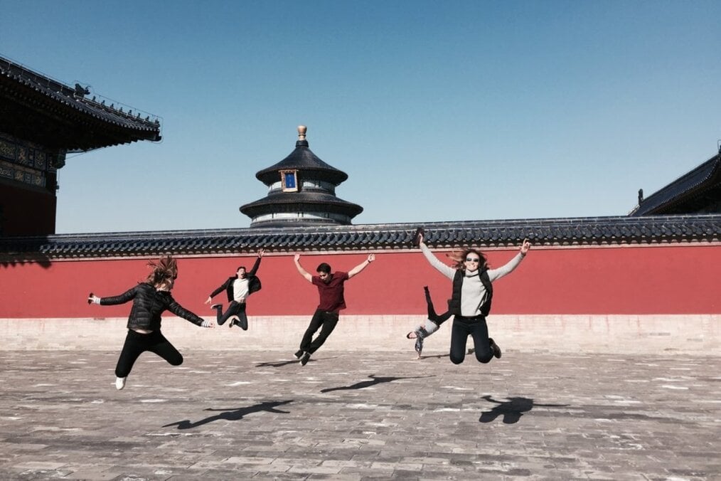 CET Greater China A group of friends jumping in the Temple of Heaven in Beijing