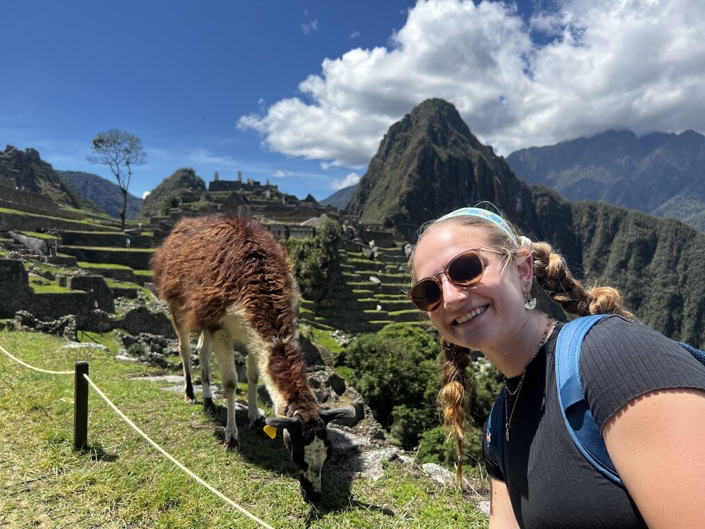 Student smiling in front of animal