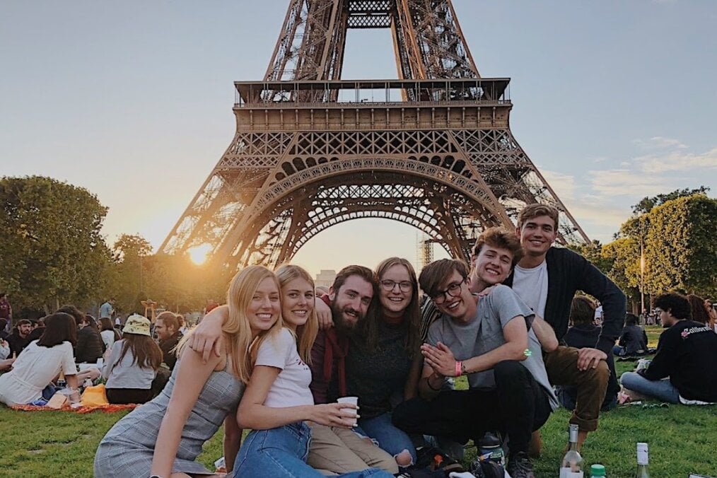 Study Abroad Paris Study abroad students relaxing by the Eiffel Tower in Paris