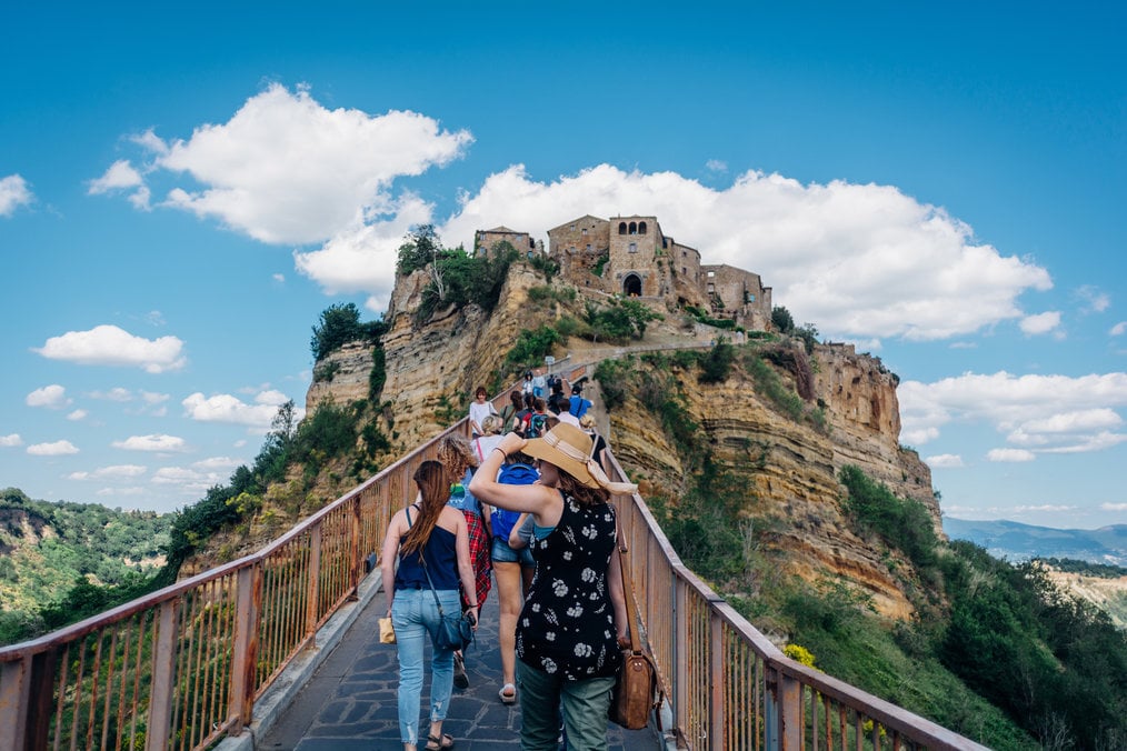 USAC study abroad A group of people walking uphill to a castle